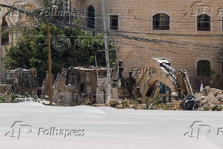 Palestinians carry their belongings after Israel's decision to demolish their homes in Nur Shams camp