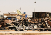 A view of a burned building and the tail of a Sudan Airways aircraft amid debris at Khartoum Airport, in Khartoum