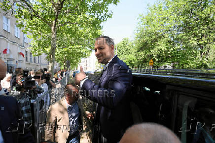 Polish presidential candidate Karol Nawrocki, backed by the main opposition Law and Justice (PiS) party, gestures after he voted