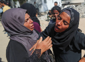 Mourners attend the funeral of Palestinians who were killed, according to medics, in Israeli fire, at Al-Shifa hospital, in Gaza City