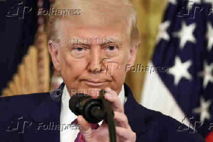 U.S. President Trump signs a resolution at the White House