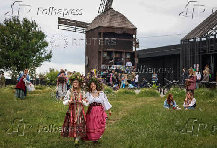 People take part in a celebration on the traditional Ivana Kupala in the village of Vytachiv, in Kyiv region