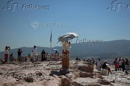 Tourists visit the Acropolis during a 3-days heatwave in Greece
