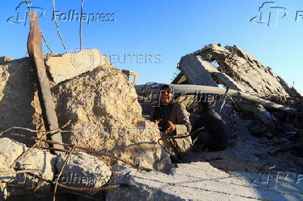 FILE PHOTO: A Palestinian woman, Hind Al-Nawajha, waits for the United Nations aid trucks entering northern Gaza, in Beit Lahia, in the northern Gaza Strip