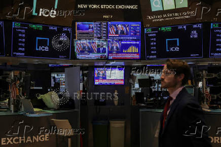 Screens display a press conference by U.S. Federal Reserve Chair Jerome Powell following the Fed rate announcement, on the floor of the NYSE in New York