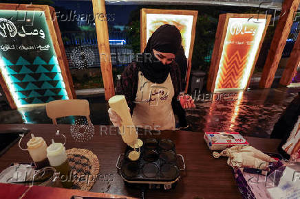 A Saudi woman prepares local sweet dish called Maseela at a Cultural and Heritage Festival in downtown Abha, Saudi Arabia