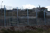 Israeli authorities encircle Palestinian town in West Bank with a fence, restricting free movement of residents