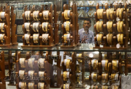 FILE PHOTO: A salesperson talks to a customer at a jewellery shop in the old quarters of Delhi