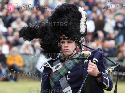 A piper competes in a band competition during the Braemar Royal Highland Gathering at the Princess Royal and Duke of Fife Memorial Park in Braemar, Scotland