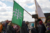 People queue up at a tomb bearing the flag with the insignia of the Iron Guard, in Bucharest