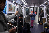 A woman holds a candy box in a subway in New York City