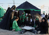 Volunteers re-enact a scene from the 7th-century Battle of Karbala to commemorate Ashura in Baghdad