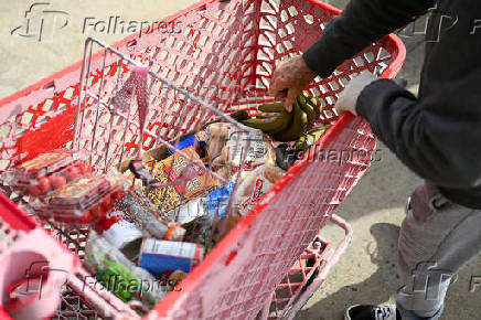 A person puts plantain in a grocery cart, outside Adams County Emergency Food Bank, weeks into the continuing U.S. government shutdown, in Commerce City