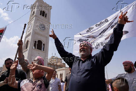 FILE PHOTO: Demonstrators protest against Israeli attacks on Syria, in Hama