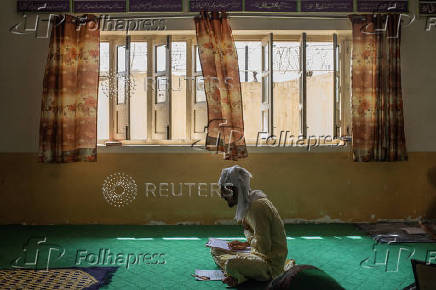 Students gives a religious studies exam at a madrasa in Multan