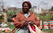 Veronica Musango weaves sisal and recycled polythene to make a traditional handwoven basket known as Kiondo at the Mwariro Market in Kariokor district of Nairobi