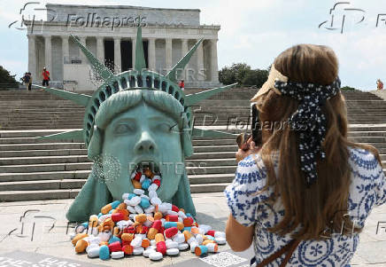 Pills spill out of the mouth a Lady Liberty installation at the Lincoln Memorial in Washington