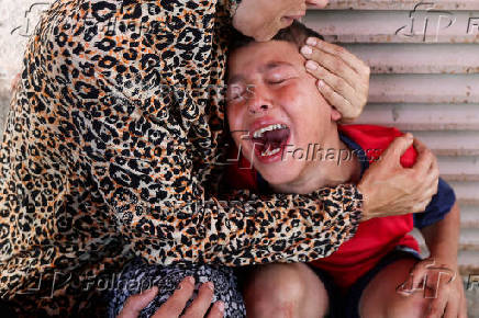 Palestinian casualties are carried into Al-Aqsa Martyrs Hospital in Deir al-Balah