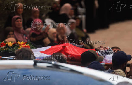 Mourners take part in the funeral of of Sayfollah Kamel Musallet, killed amid the Israel-Gaza conflict, near Ramallah