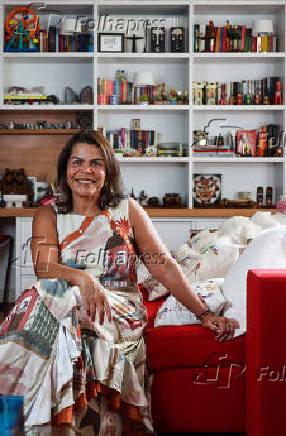 Daniela Falcão posa com obra em casa durante entrevista