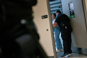 A migrant is detained by federal immigration officers at U.S. immigration court