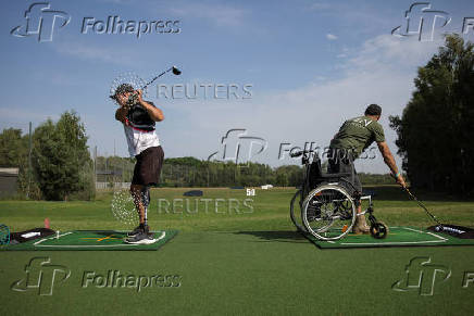 Ukrainian war veterans take part in a golf tournament outside of Kyiv