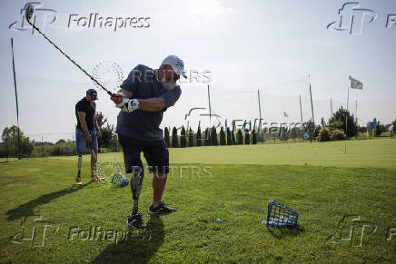 Ukrainian war veterans take part in a golf tournament outside of Kyiv