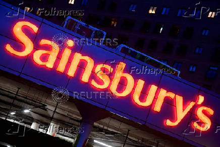 FILE PHOTO: Illuminated signage is seen at a branch of the Sainsbury's supermarket in London