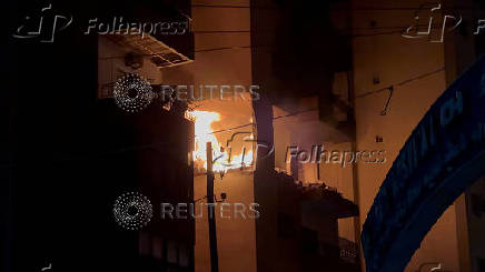 Fire burns at a building floor following an Israeli strike, in which the Israeli military said, it killed Hamas commander Hassan Farhat, in Sidon