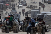 Displaced Palestinians flee their homes in the town of Beit Lahia, north of Gaza City,