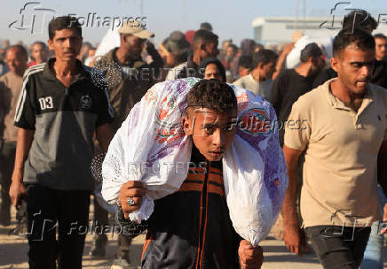 Palestinians receive aid from the U.S.-backed Gaza Humanitarian Foundation, in Khan Younis