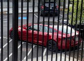 A Tesla vehicle is parked on West Executive Avenue near the White House in Washington