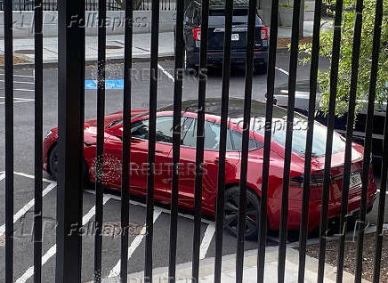 A Tesla vehicle is parked on West Executive Avenue near the White House in Washington