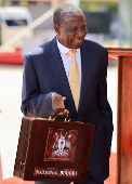 Uganda Minister for Finance Matia Kasaija holds the briefcase containing the Government Budget for the 2025/26 fiscal year at the Kololo Independence grounds in Kampala