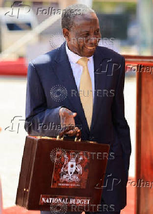 Uganda Minister for Finance Matia Kasaija holds the briefcase containing the Government Budget for the 2025/26 fiscal year at the Kololo Independence grounds in Kampala