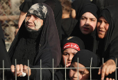 Volunteers re-enact a scene from the 7th-century Battle of Karbala to commemorate Ashura in Baghdad