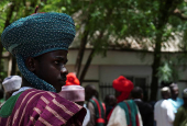 Mourners wait to gain access to former president Buhari's residence ahead of his burial