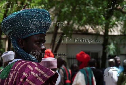 Mourners wait to gain access to former president Buhari's residence ahead of his burial