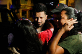 Arturo Suarez, who was held for months in an El Salvador prison, greets family members after his release, in Caracas
