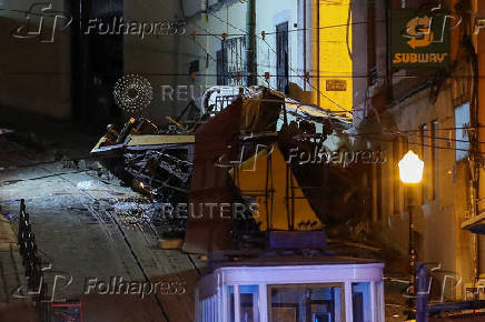 First responders work at the site of a funicular accident in Lisbon
