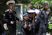 World War Two veteran Nikolai Golubtsov receives congratulations on the upcoming Victory Day in Sevastopol