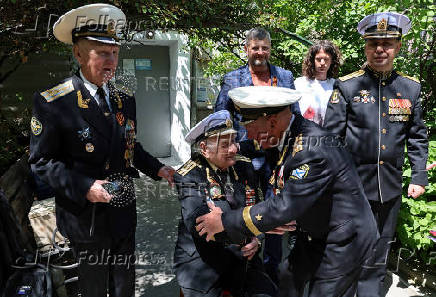 World War Two veteran Nikolai Golubtsov receives congratulations on the upcoming Victory Day in Sevastopol
