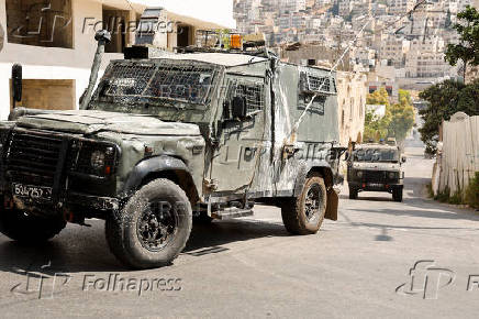 Israeli military vehicles manoeuvre during an Israeli raid in Nablus