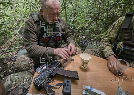 Ukrainian servicemen hold a position in the Kharkiv region