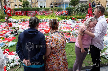 Fans pay their respects outside Anfield Stadium, on the day of the funeral of Liverpool soccer player Diogo Jota in Portugal, in Liverpool