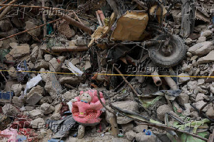 Personal belongings lie amid the rubble of a five-storey residential building that collapsed on Friday, July 4, in Karachi