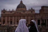 Nuns stand in front of St. Peter's Basilica, at St. Peter's Square in the Vatican
