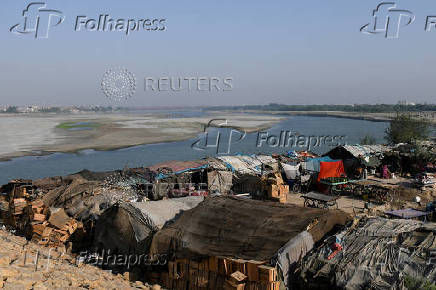 FILE PHOTO: FILE PHOTO: A view of tent houses, belonging to squatters, on the dry riverbed of the Indus River in Hyderabad