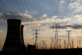 FILE PHOTO: Electricity pylons are seen along the cooling tower of the defunct Orlando Power Station in Soweto