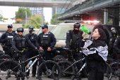 A protester demonstrates outside Calgary Municipal Building, on the first day of the G7 Leaders' Summit, in Calgary